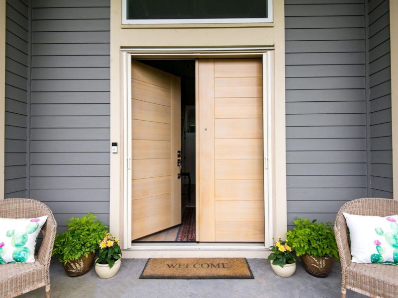 Modern outdoor dining pavilion with motorized Phantom screens lowered across wide openings, revealing forest view beyond.